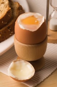 A4GBR4 Soft boiled egg with the top off in a breakfast setting.