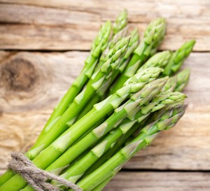 Asparagus on the wooden background.